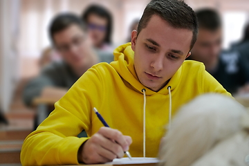 Image showing student taking notes while studying in high school