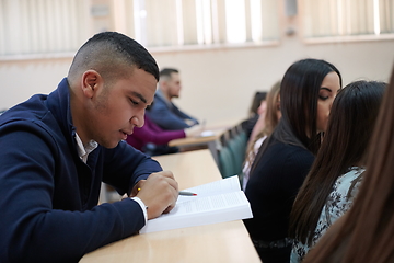 Image showing student taking notes while studying in high school