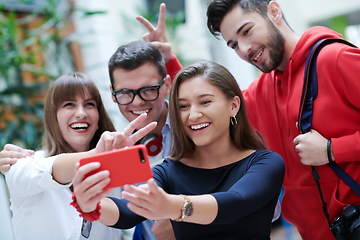 Image showing Group of multiethnic teenagers taking a selfie in school