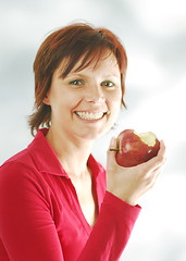 Image showing A woman with an apple
