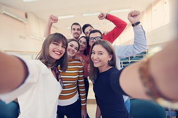 Image showing Group of multiethnic teenagers taking a selfie in school