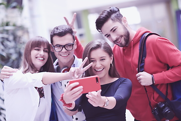 Image showing Group of multiethnic teenagers taking a selfie in school