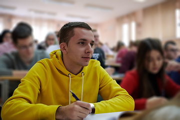 Image showing student taking notes while studying in high school