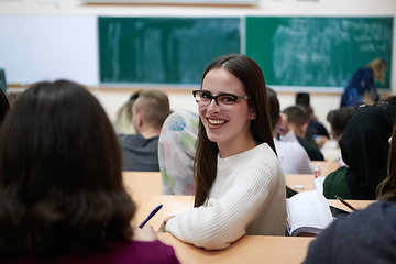 Image showing girl sitting in an amphitheater and talking to her colleagues