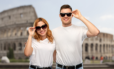 Image showing happy couple in sunglasses over coliseum