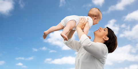 Image showing happy middle-aged mother with little baby daughter