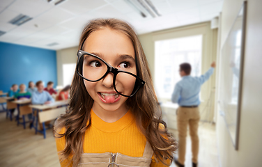 Image showing smiling teenage student girl in glasses at school