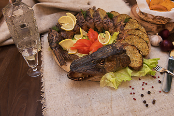 Image showing Stuffed pike with vegetables and greens.