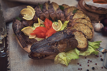 Image showing Stuffed pike with vegetables and greens.