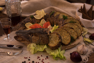 Image showing Stuffed pike with vegetables and greens.