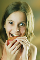 Image showing A girl with an apple