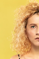 Image showing Caucasian young woman\'s close up portrait on yellow background