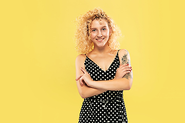 Image showing Caucasian young woman\'s half-length portrait on yellow background