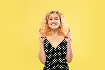 Image showing Caucasian young woman\'s half-length portrait on yellow background