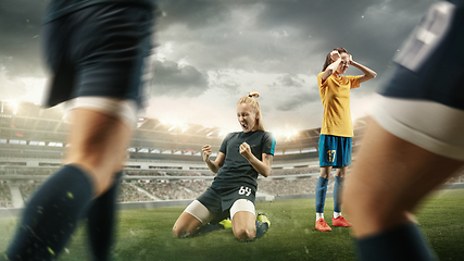 Image showing Female soccer or football players kicking ball at the stadium
