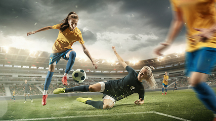 Image showing Female soccer or football players kicking ball at the stadium