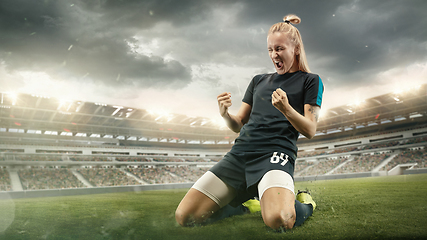 Image showing Female soccer or football players kicking ball at the stadium