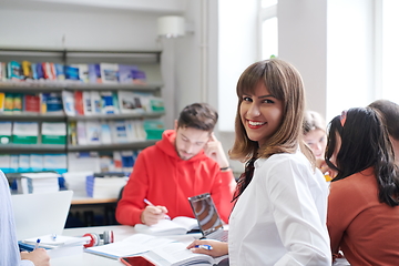 Image showing students group working on school project together on tablet computer at modern university