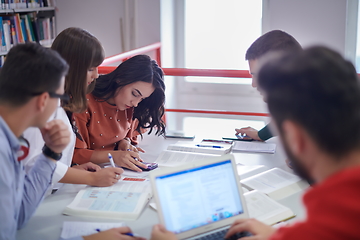 Image showing students group working on school project together on tablet computer at modern university