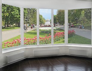Image showing window overlooking the city park where people have a rest