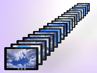 Image showing tablets in row with different images of sky