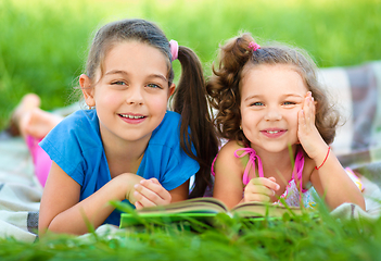 Image showing Two little girls are reading book