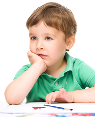 Image showing Little boy is playing with paints