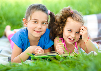 Image showing Two little girls are reading book