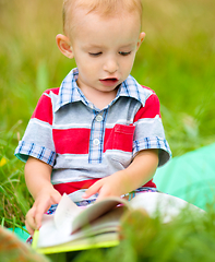 Image showing Little boy is reading book