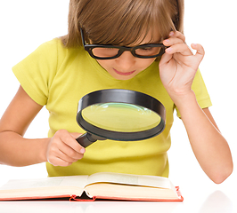 Image showing Little girl is reading book