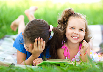 Image showing Two little girls are reading book