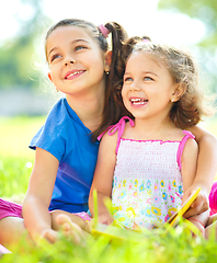 Image showing Two little girls are reading books