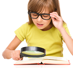 Image showing Little girl is reading book