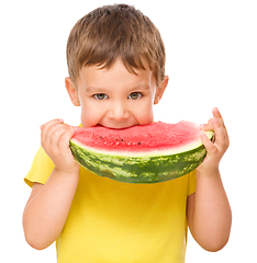 Image showing Little boy is eating watermelon