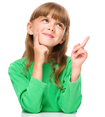 Image showing Portrait of a young girl pointing up