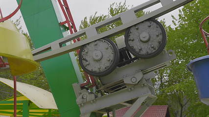 Image showing Underside view of a ferris wheel over blue sky.