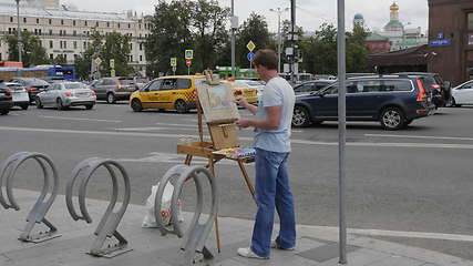 Image showing MOSCOW - AUGUST 26: Street artist paints a urban landscape on August 26, 2017 in Moscow, Russia.