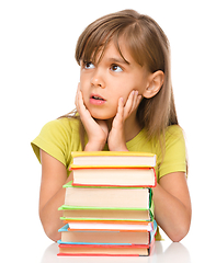 Image showing Little girl with a pile of books