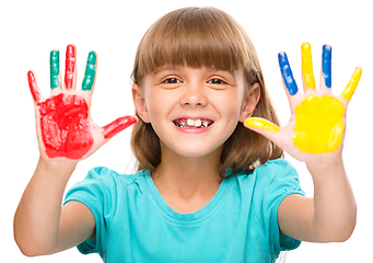 Image showing Portrait of a cute girl playing with paints