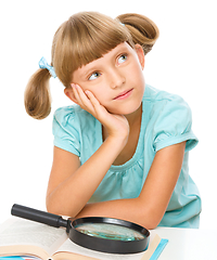 Image showing Little girl is reading book