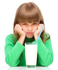 Image showing Gloomy little girl doesn\'t want to drink milk