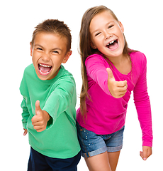 Image showing Little boy and girl are showing thumb up sign