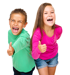 Image showing Little boy and girl are showing thumb up sign