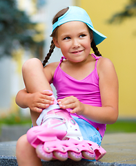 Image showing Little girl is wearing roller-blades