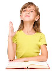 Image showing Little girl is rising her hand up