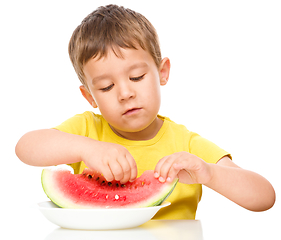 Image showing Little boy is eating watermelon