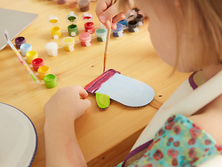 Image showing Cute little girl painting on home interior background