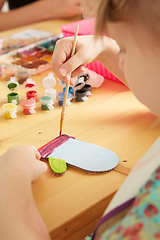 Image showing Cute little girl painting on home interior background