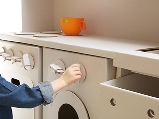 Image showing Child girl playing with toy kitchen at home