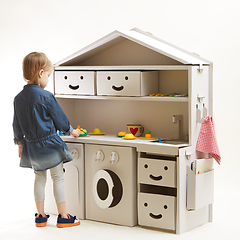 Image showing toddler girl playing with toy kitchen at home